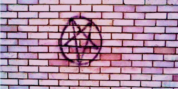 Pentagram painted on a brick wall, photo by Thomas Lee-Smith