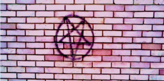 Witchcraft Activism, by David Salisbury Pentagram painted on a brick wall, photo by Thomas Lee-Smith