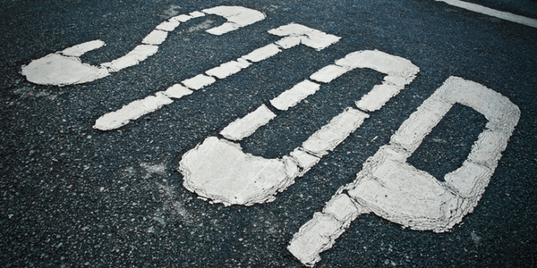 Stop sign on the road, photo by Tomás Fano