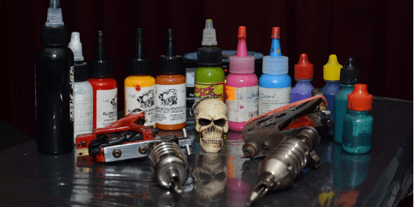 Tattoo machine, ink, and small skull, photo by diegoservelion
