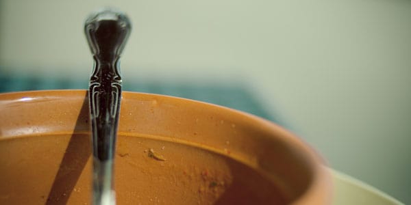 Empty soup bowl with spoon, photo by Allan Foster
