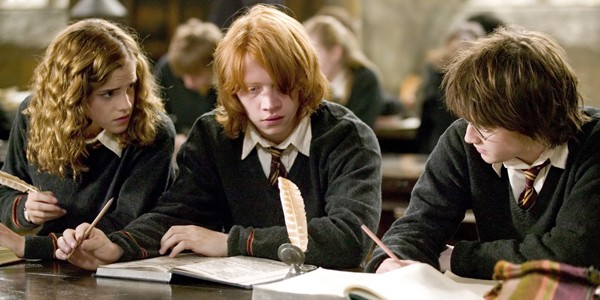 Hermione Granger, Ron Weasley, and Harry Potter studying